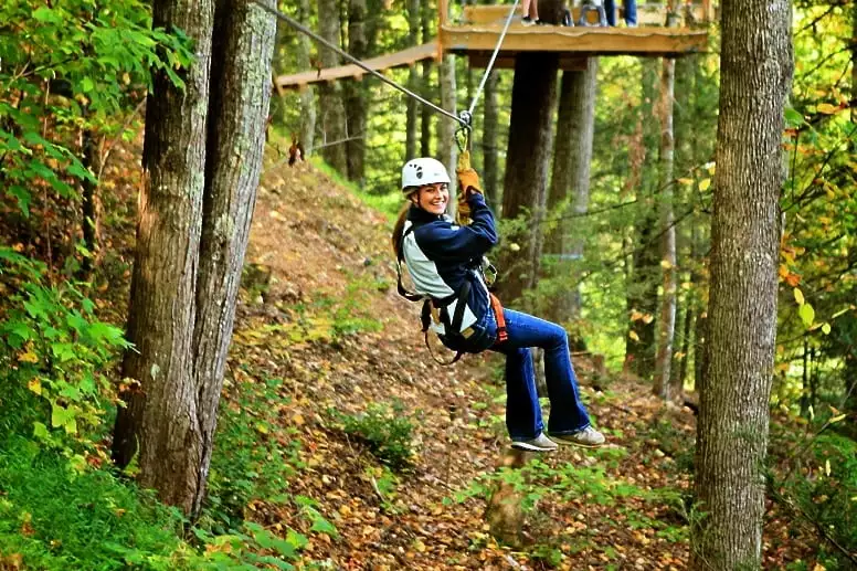 young woman ziplining near Gatlinburg TN